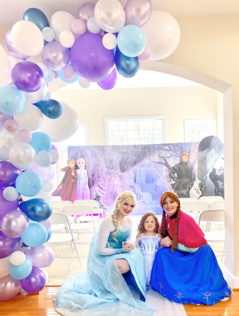 Two women dressed as Elsa and Anna