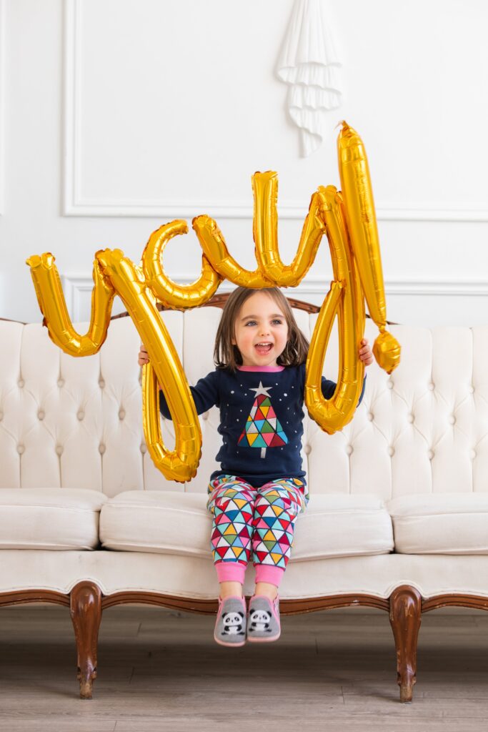 A little girl with a gold balloon