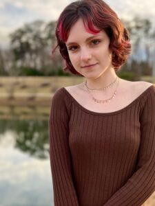 A girl standing next to a river